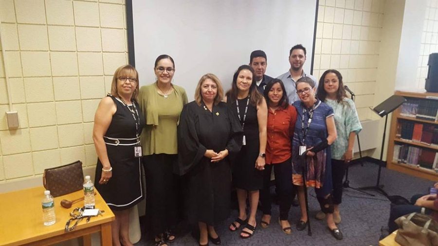 New York State Supreme Court Judge Carmen Velasquez stands with PHS administration and staff. 
